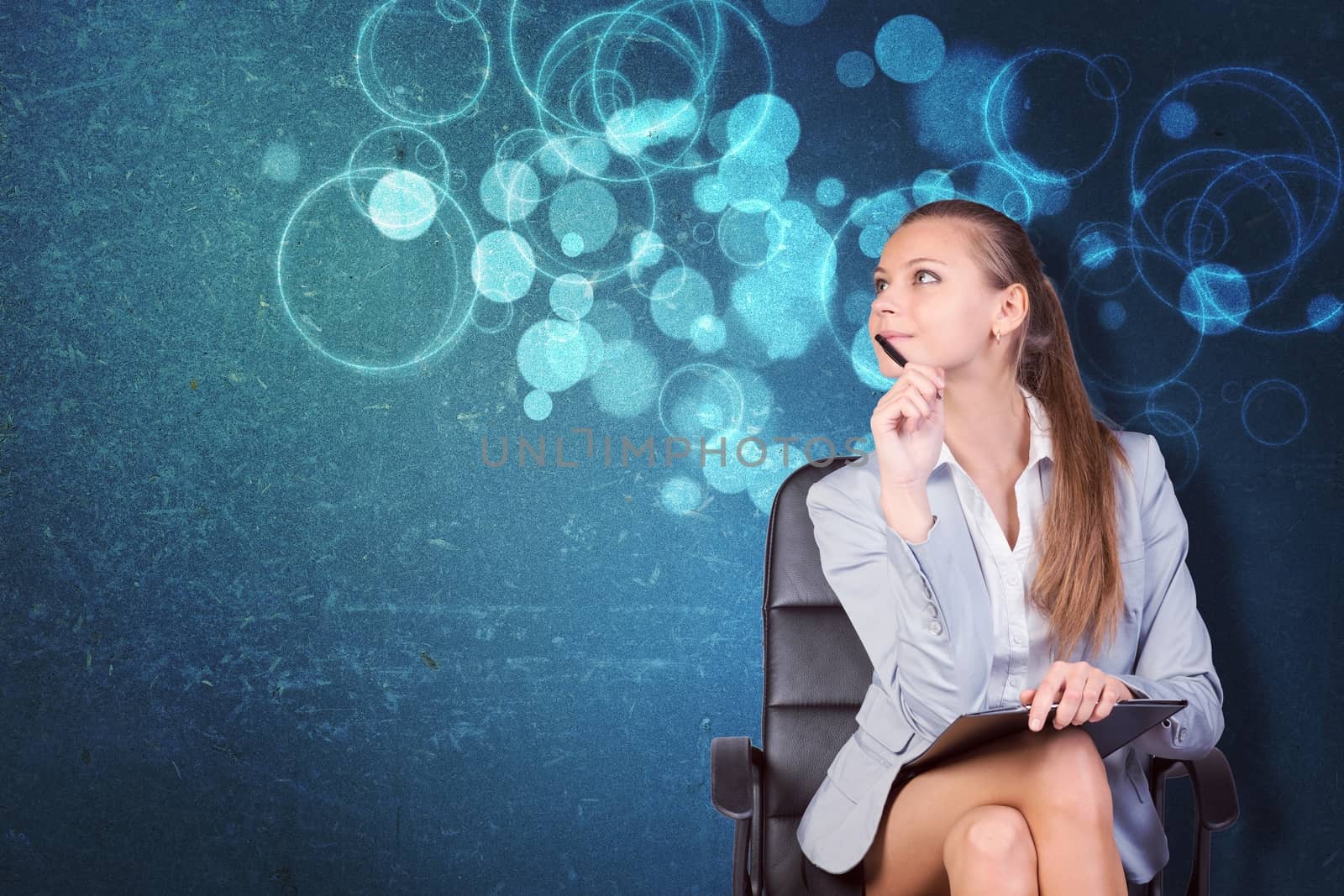 Woman in jacket and blouse sits on chair and looking up. Abstract background