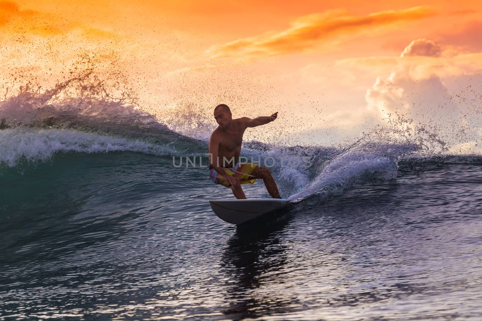 Surfer on Amazing Wave at sunset time, Bali island.