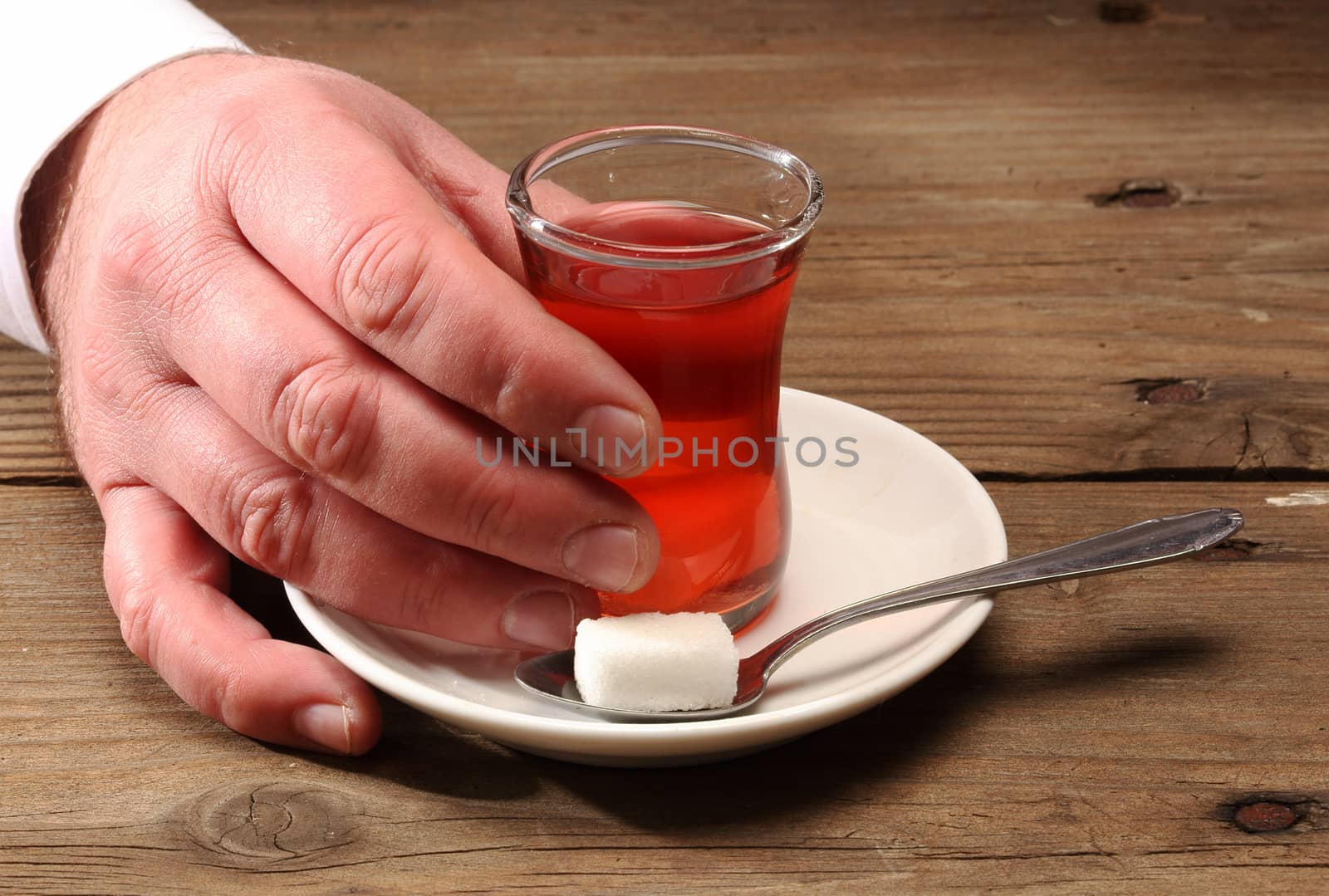 Hand holding a cup of Turkish tea 