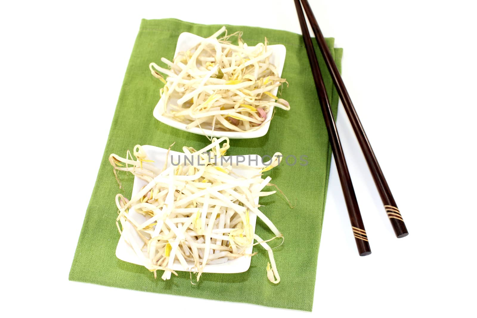 mung bean sprouts with dark chopsticks on a light background
