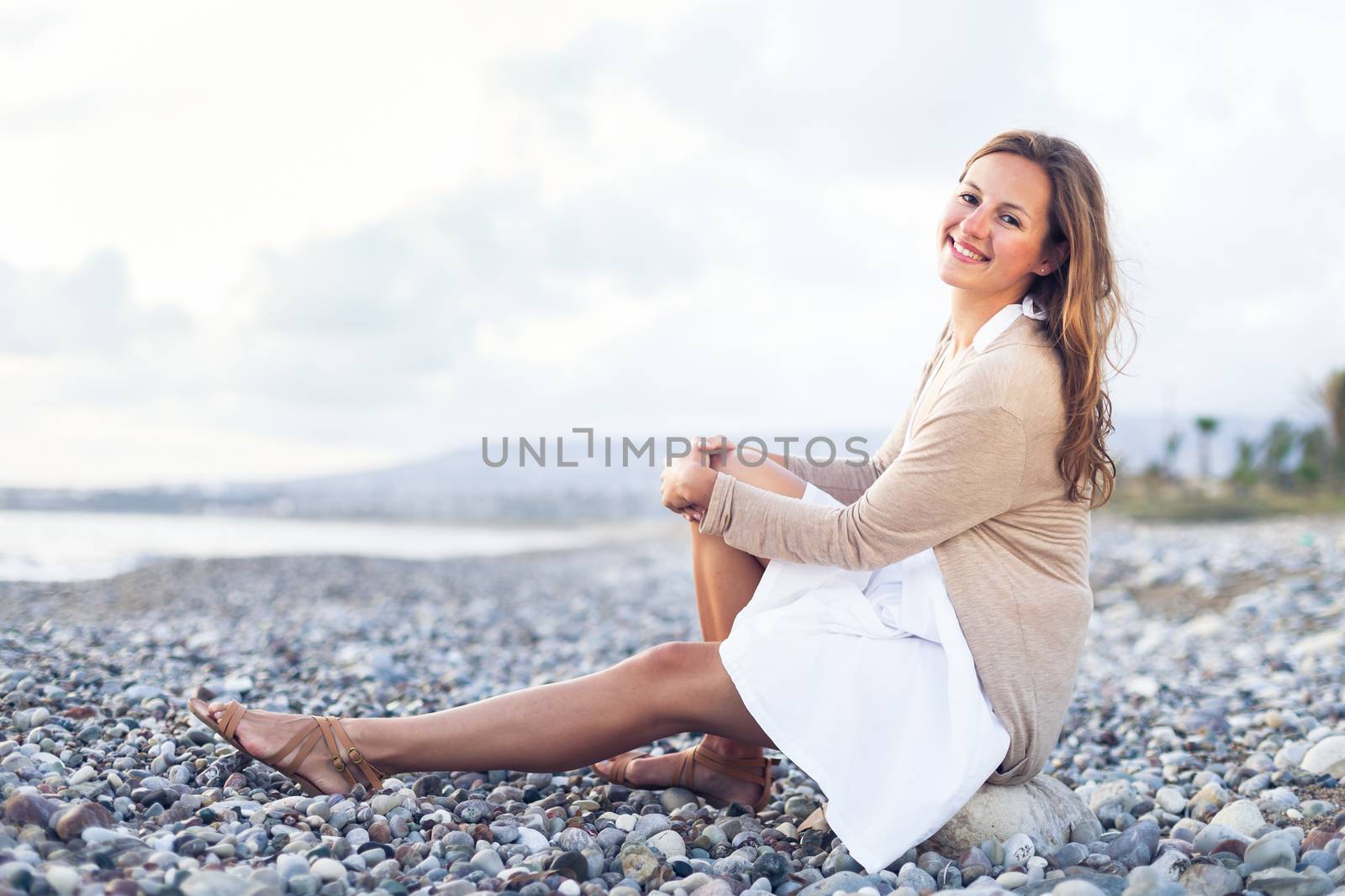 Young woman on the beach enjoying a warm summer evening by viktor_cap