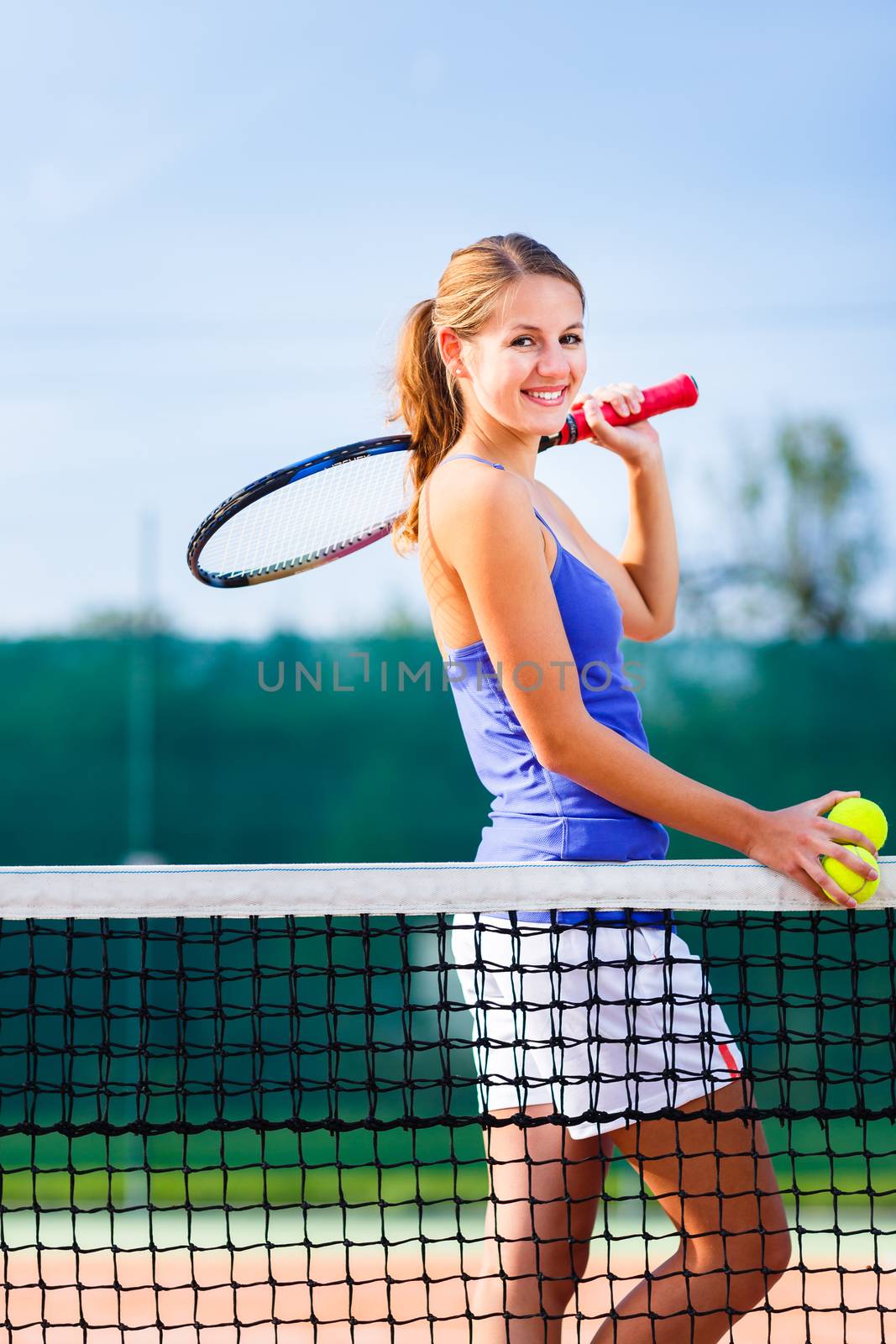 Portrait of a pretty young tennis player with copyspace