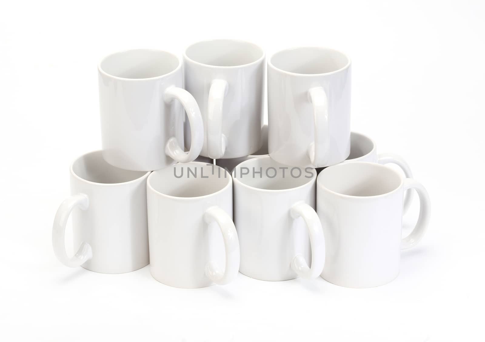 stack of white ceramic cups over white