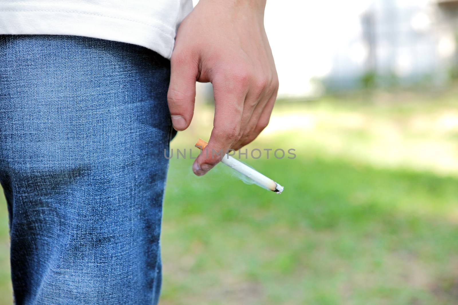 Man hold a Cigarette in the Hand closeup outdoor