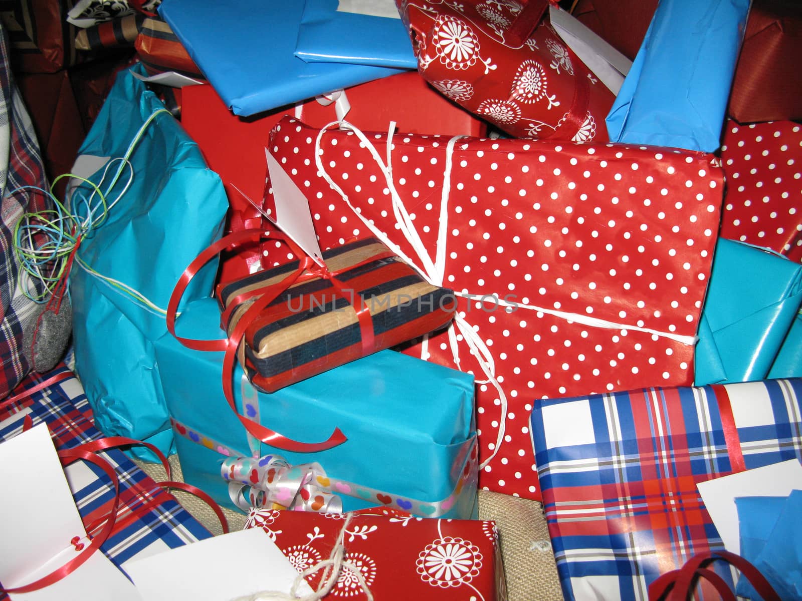 Wrapped christmas gifts with paper patterns, decors in red, white and blue.