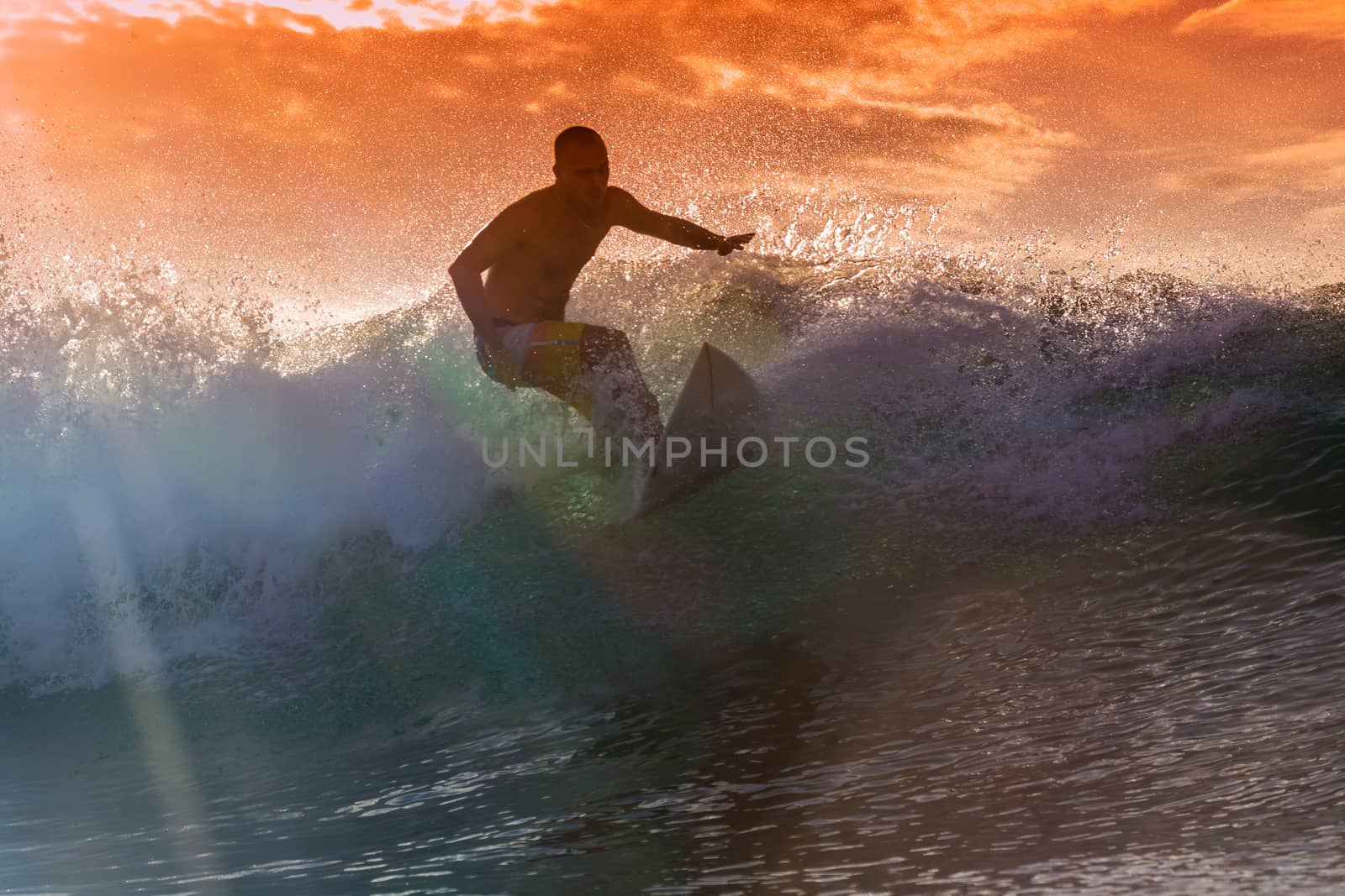 Surfer on Amazing Wave at sunset time, Bali island.