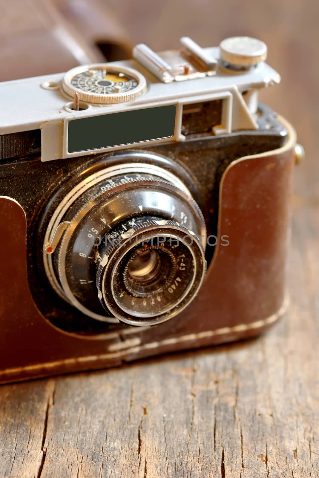 Old film camera on wooden background