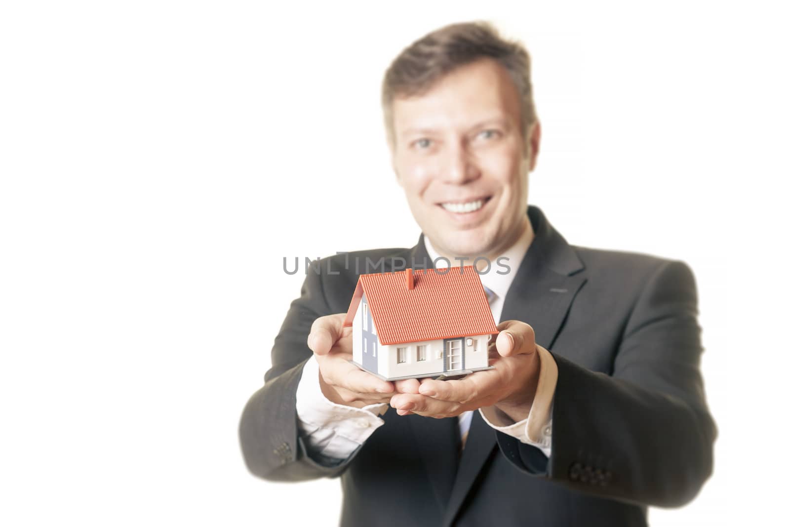 An image of a man holding a house in his hands