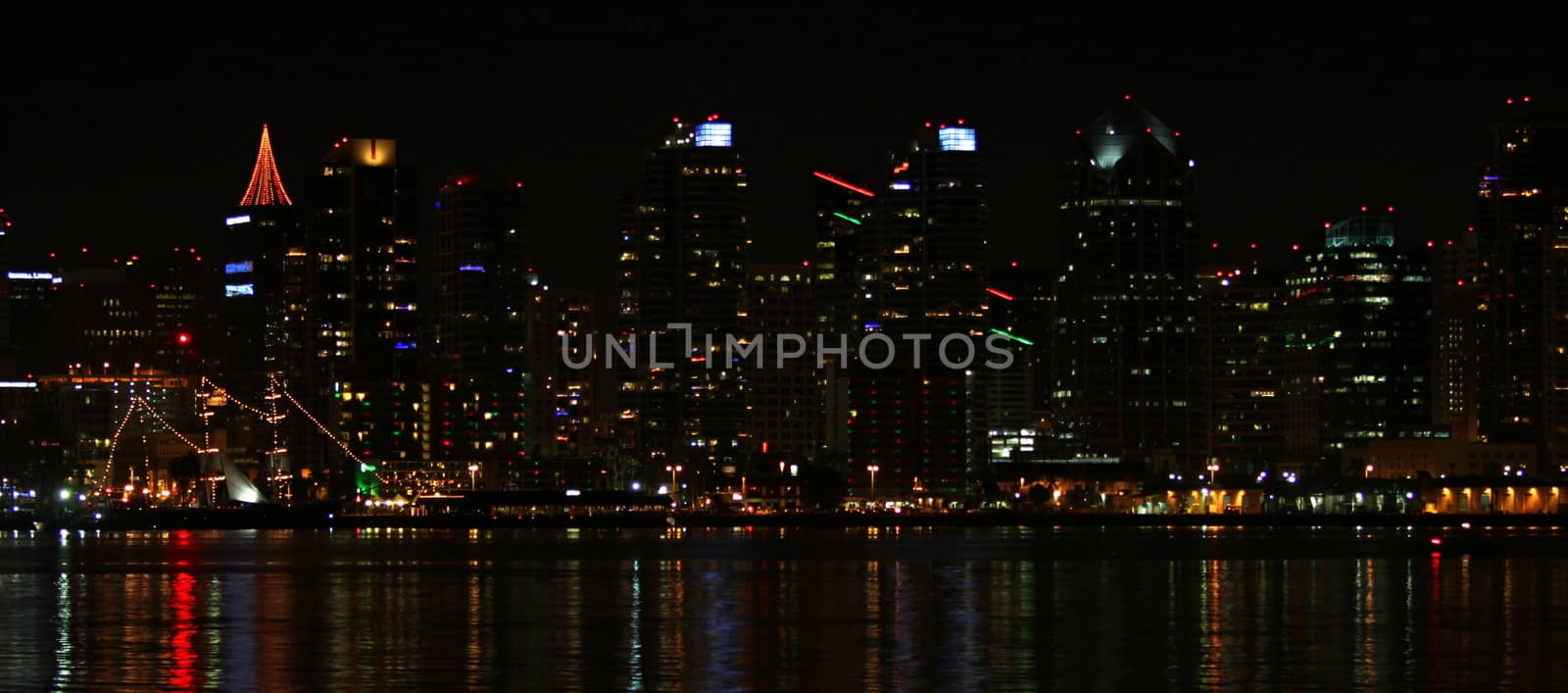 The skyline of San Diego at night with reflection in the water.