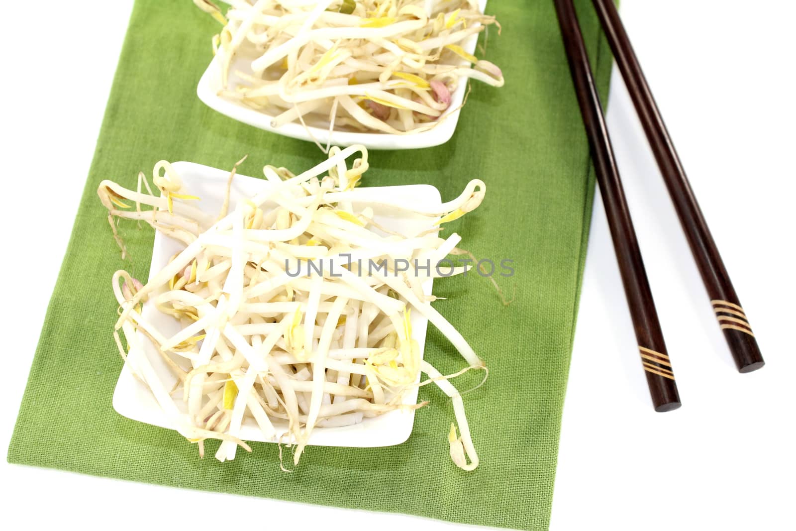 bright mung bean sprouts with chopsticks on a light background