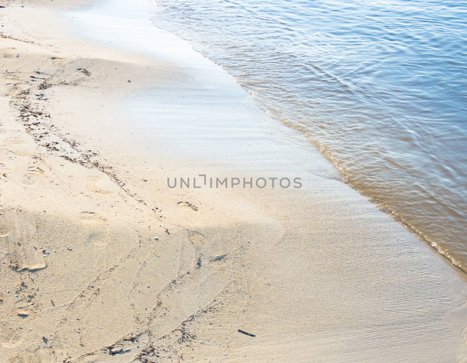 Water edge sandy beach. Mallorca, Balearic islands, Spain in July.