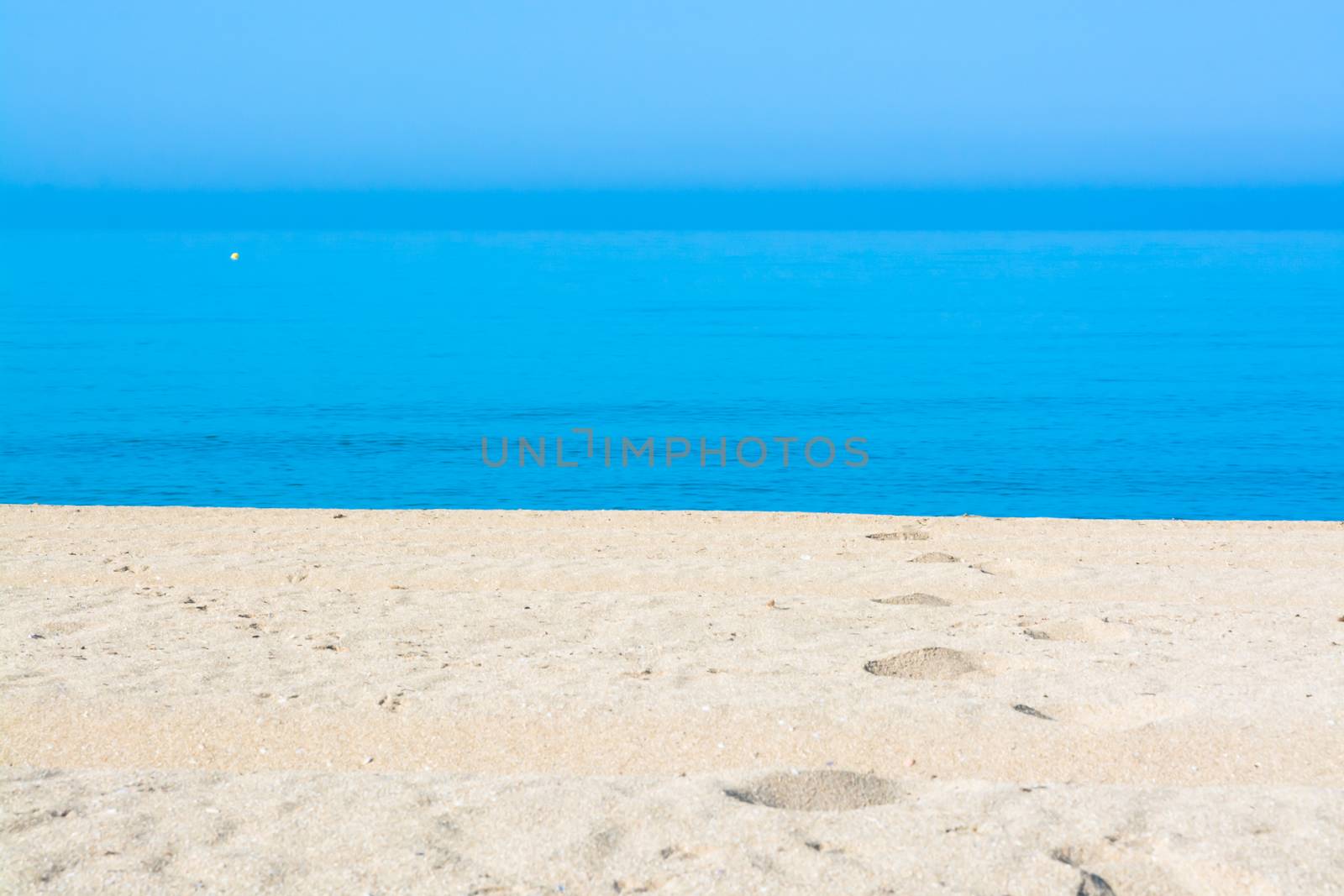 Sand tracks and footprints into the water. Mallorca, Balearic islands, Spain.
