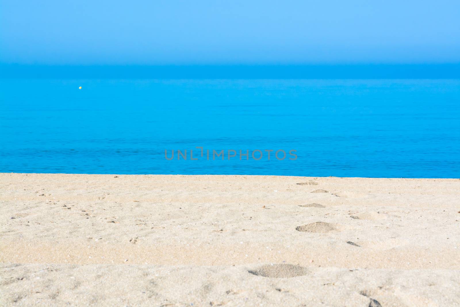 Sand tracks and footprints into the water. Mallorca, Balearic islands, Spain.