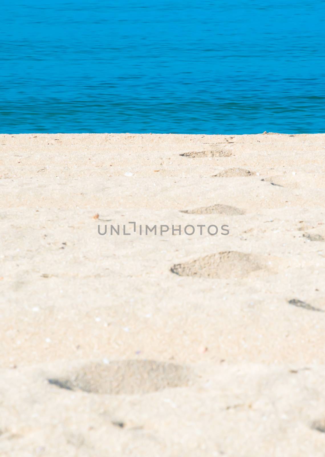 Sand tracks and footprints into the water. Mallorca, Balearic islands, Spain.