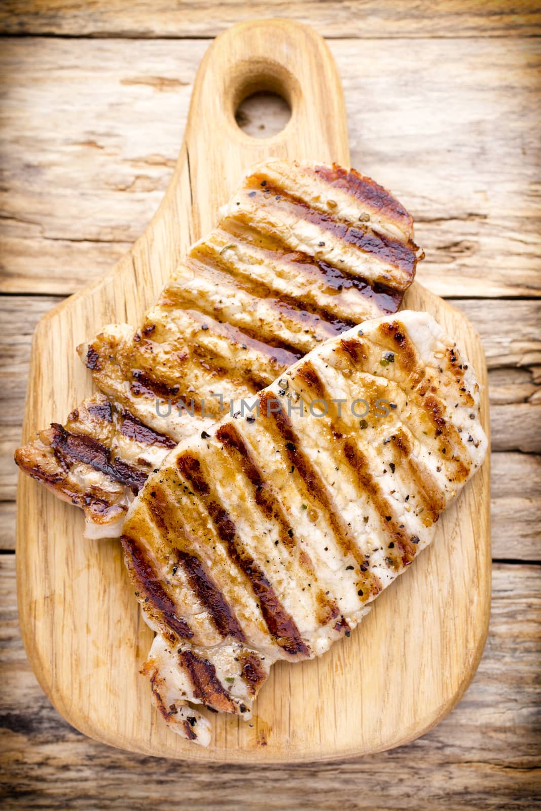 Grilled pork chops pieces. Spices and rosemary.