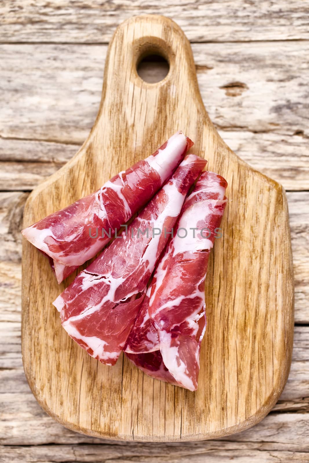 Dried pig meat slices. Delicatess.