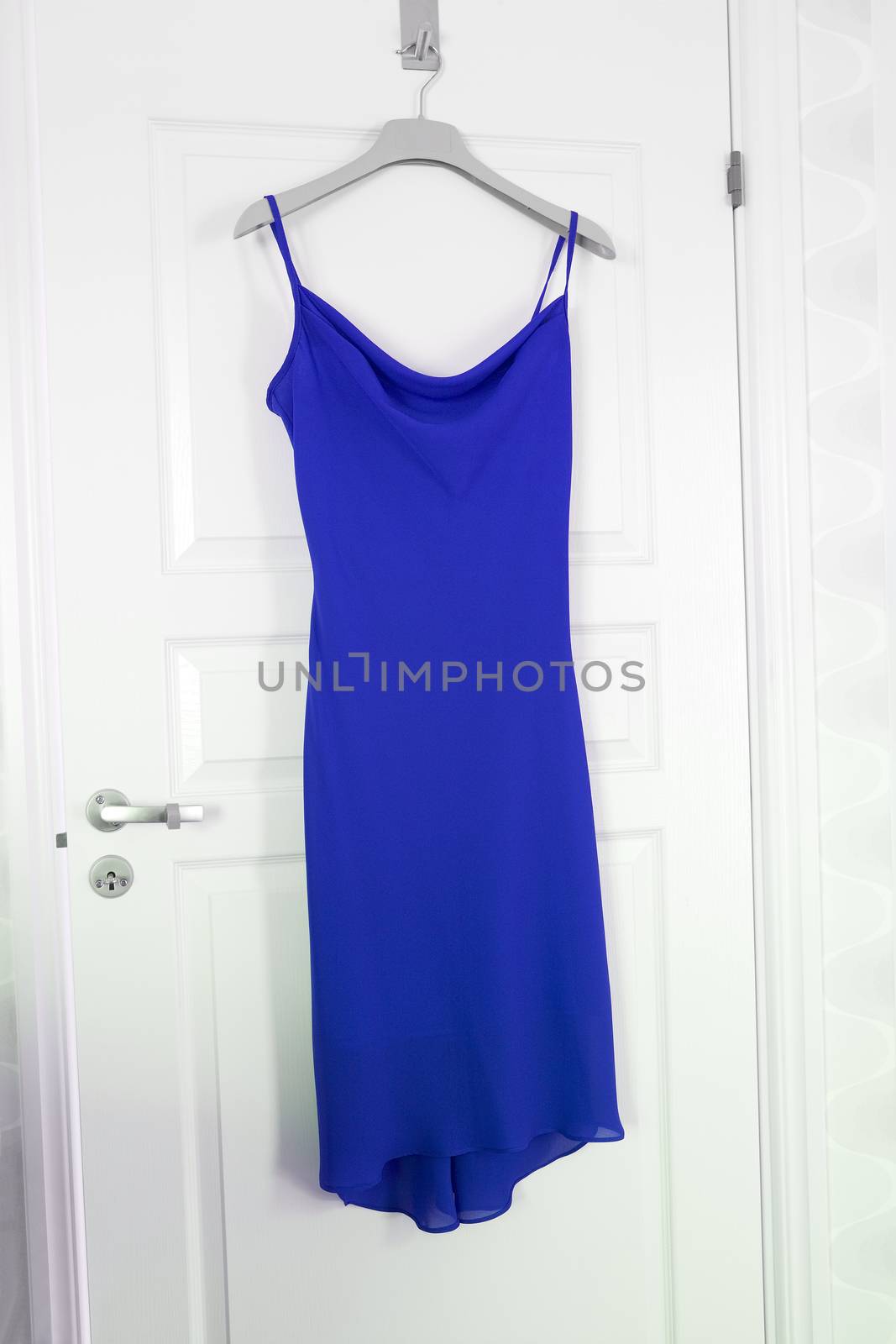 Blue Dress hanging on a door