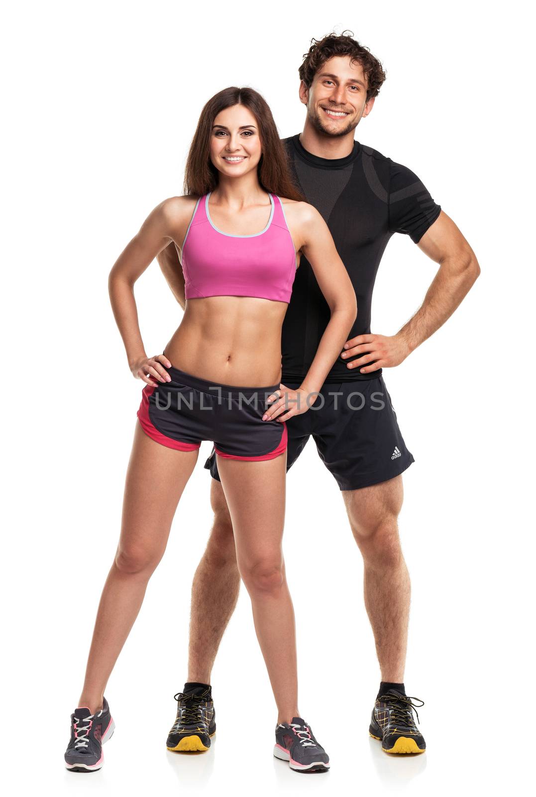 Sport couple - man and woman after fitness exercise on the white background