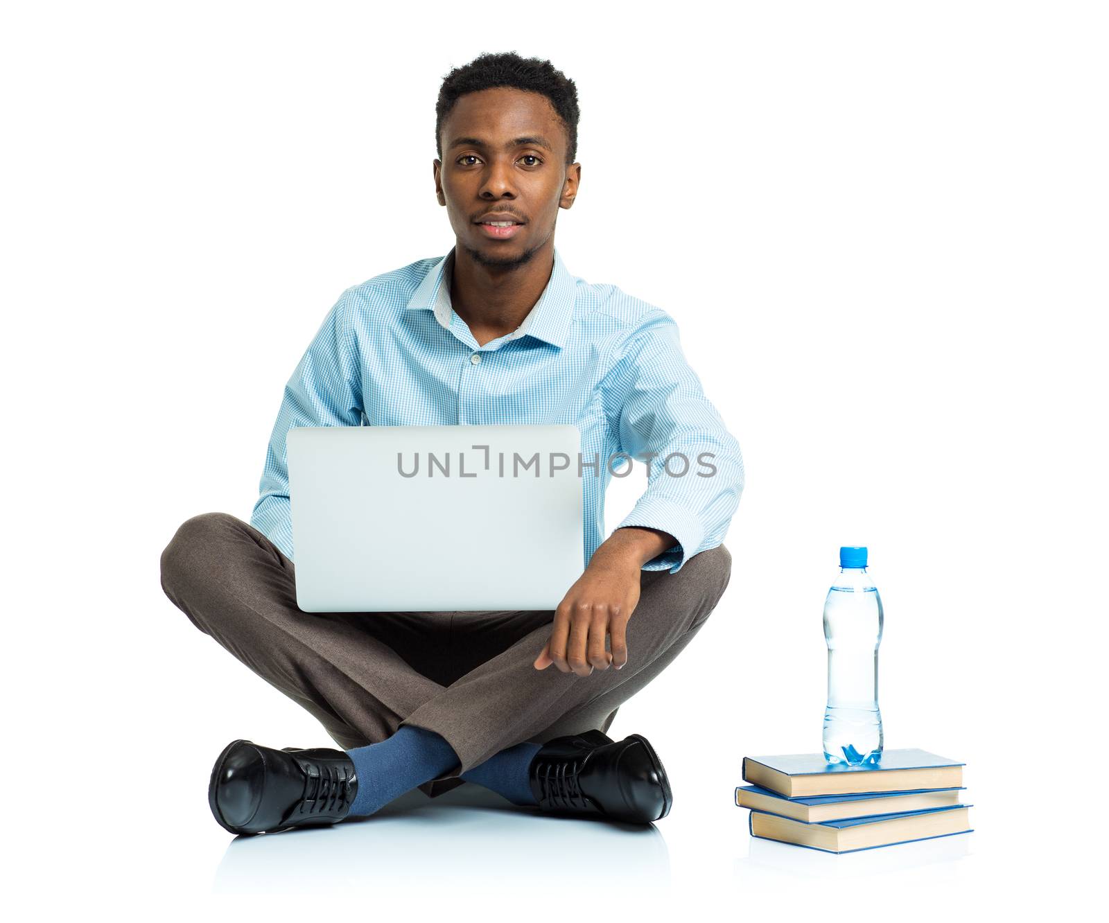 African american college student sitting with laptop on white ba by vlad_star