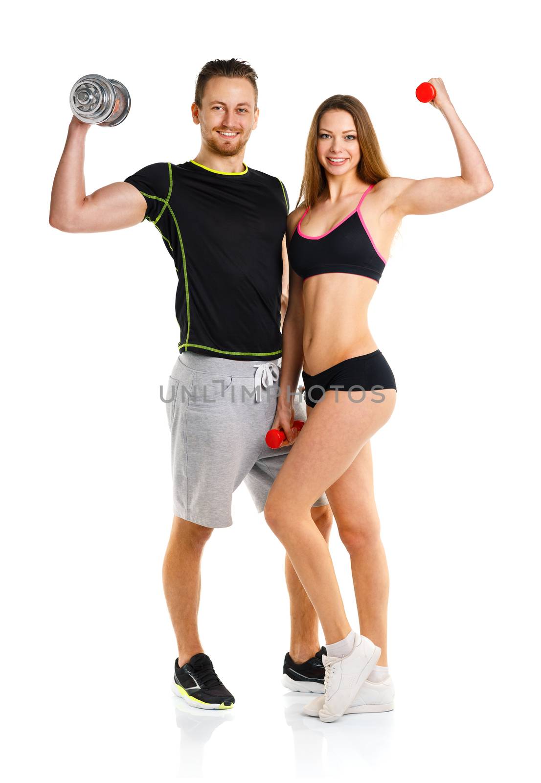 Sport couple - man and woman with dumbbells on the white background