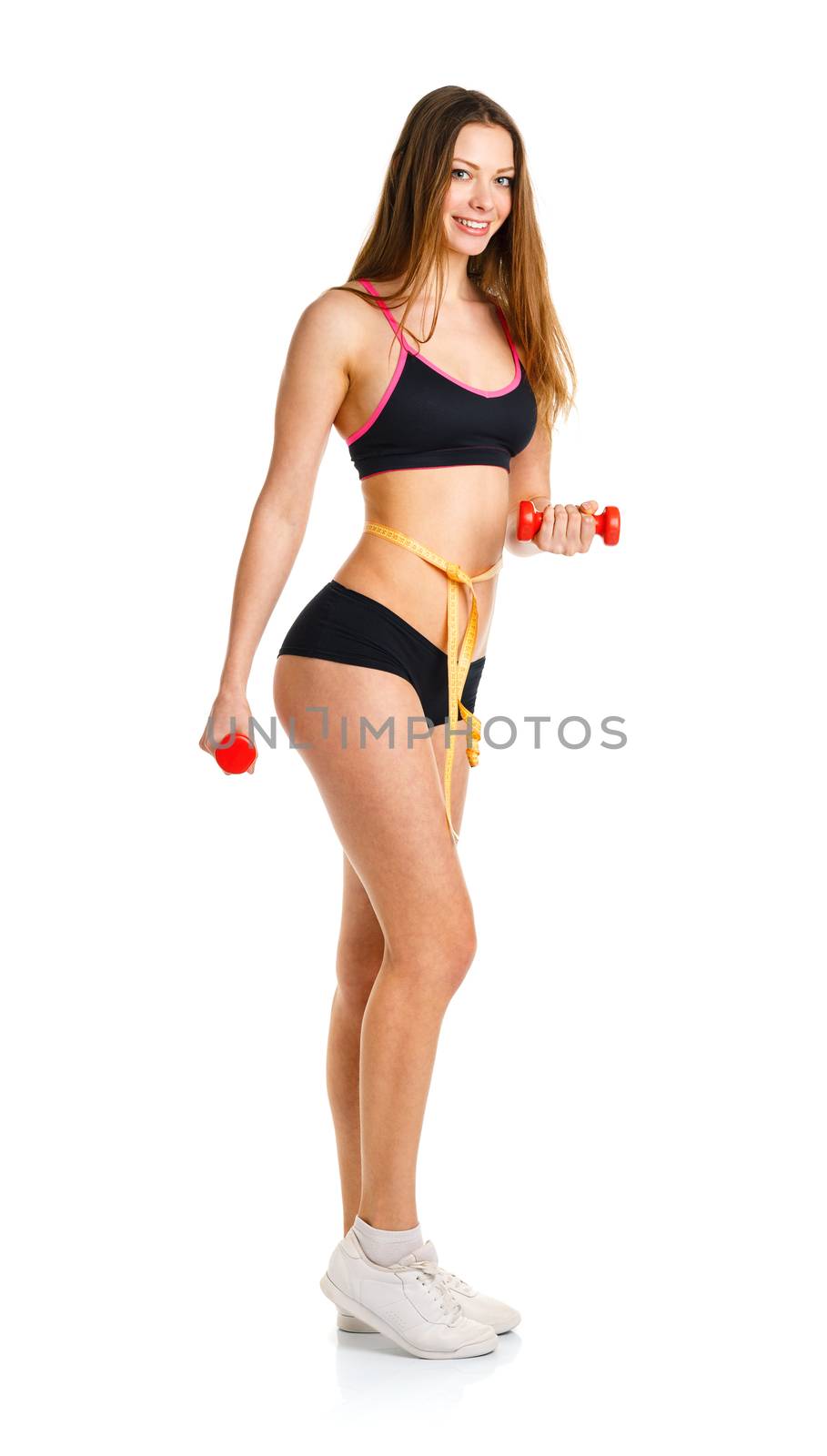 Beautiful athletic woman with dumbbells and  measuring tape on waist doing sport exercise, isolated on white background