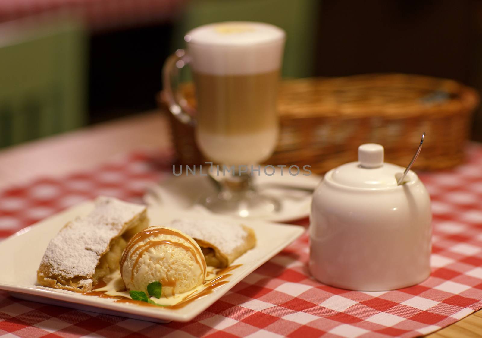 Coffee latte in glass cup and and strudel with ice cream on a ta by vlad_star