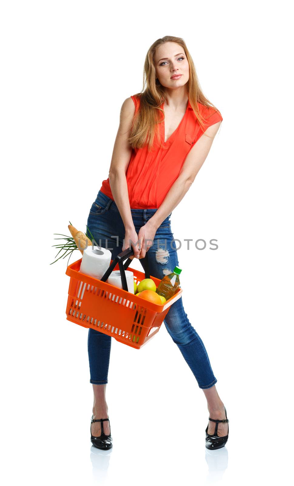 Young caucasian woman with assorted grocery products in shopping basket isolated on white background