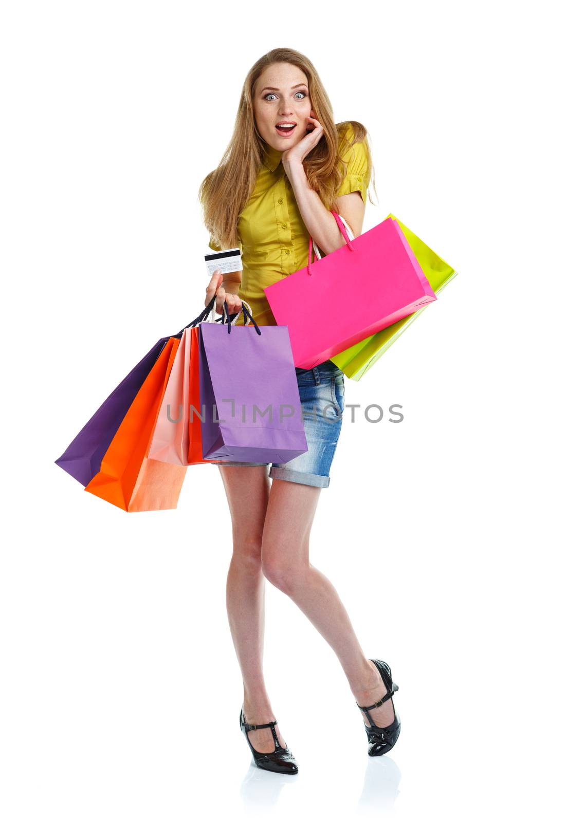 Happy caucasian woman with shopping bags and holding credit card on white background. Holidays concept