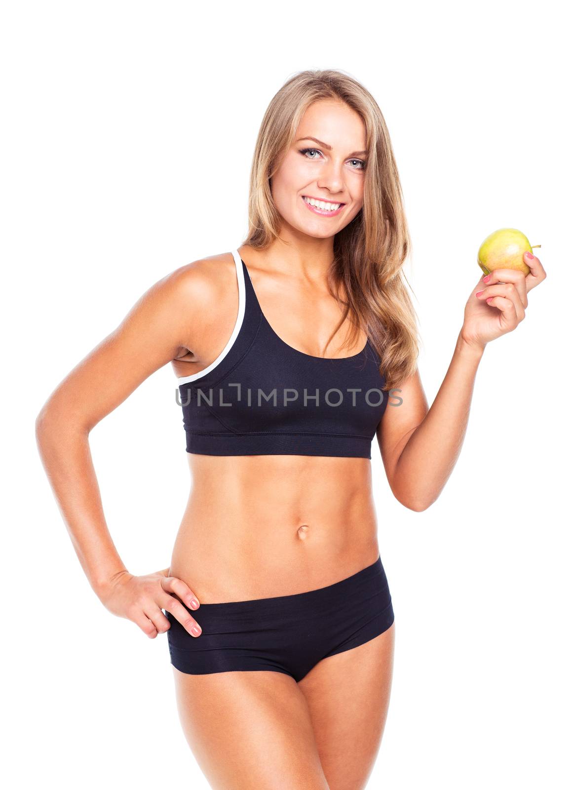 Young smiling girl holding green apple in hand by vlad_star