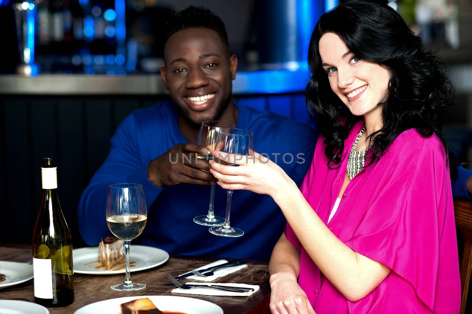 Happy amorous couple toasting appetizer