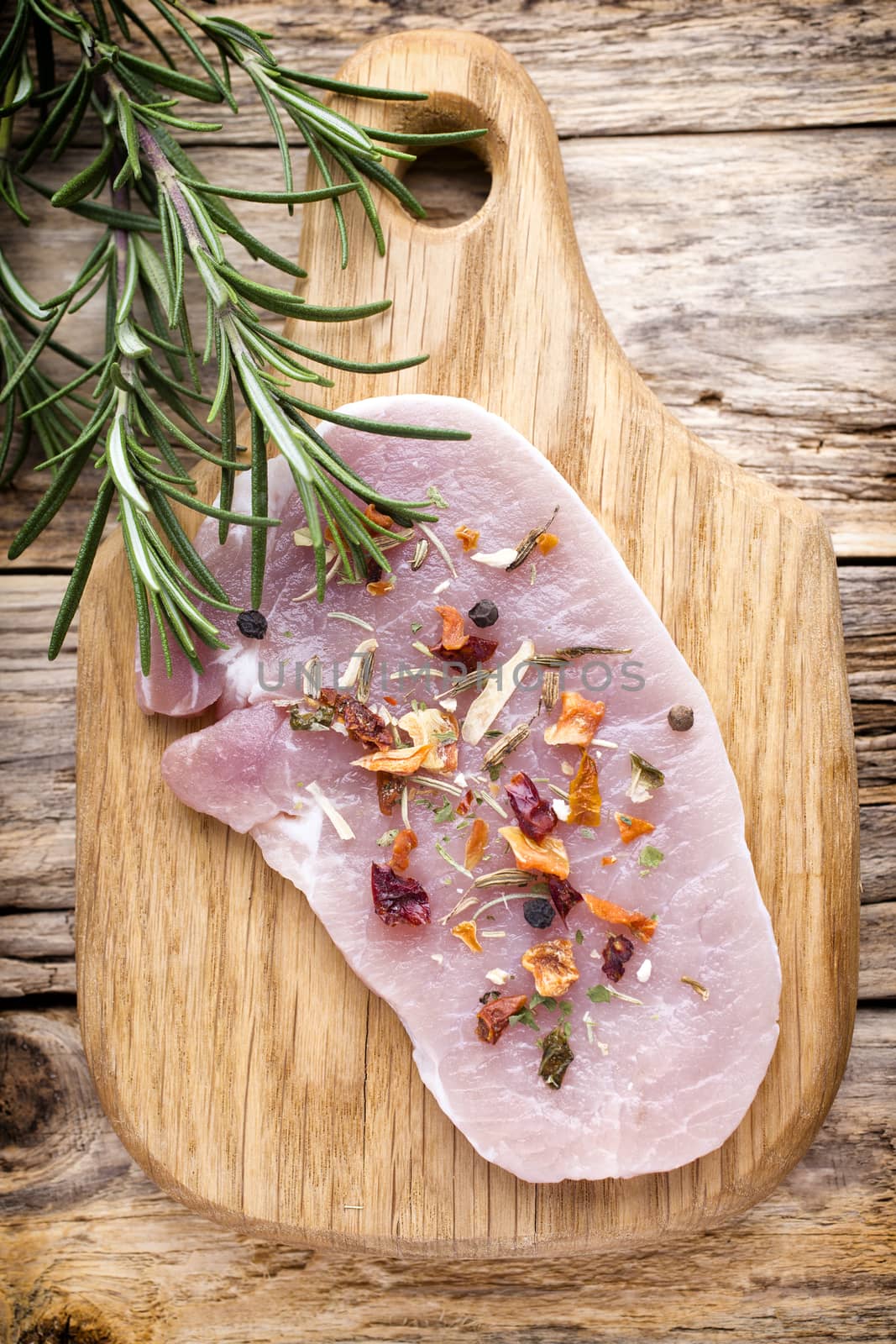 Pork chop, meat slices  on a wood background.