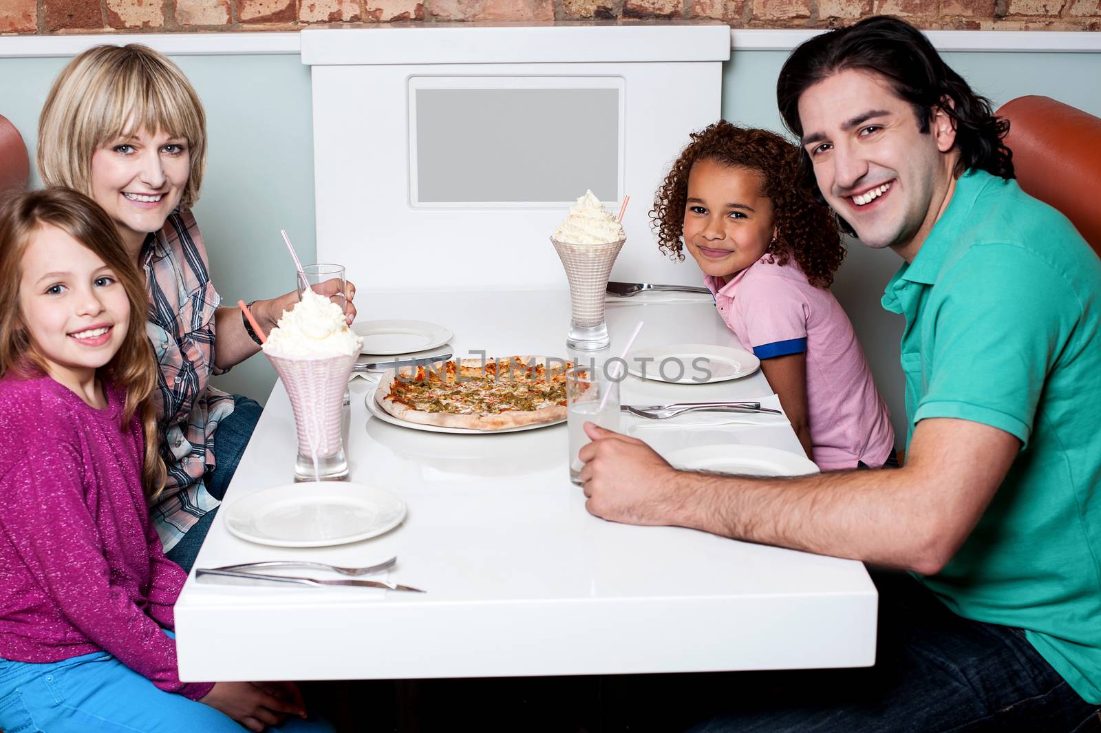 Happy family sitting together in a restaurant