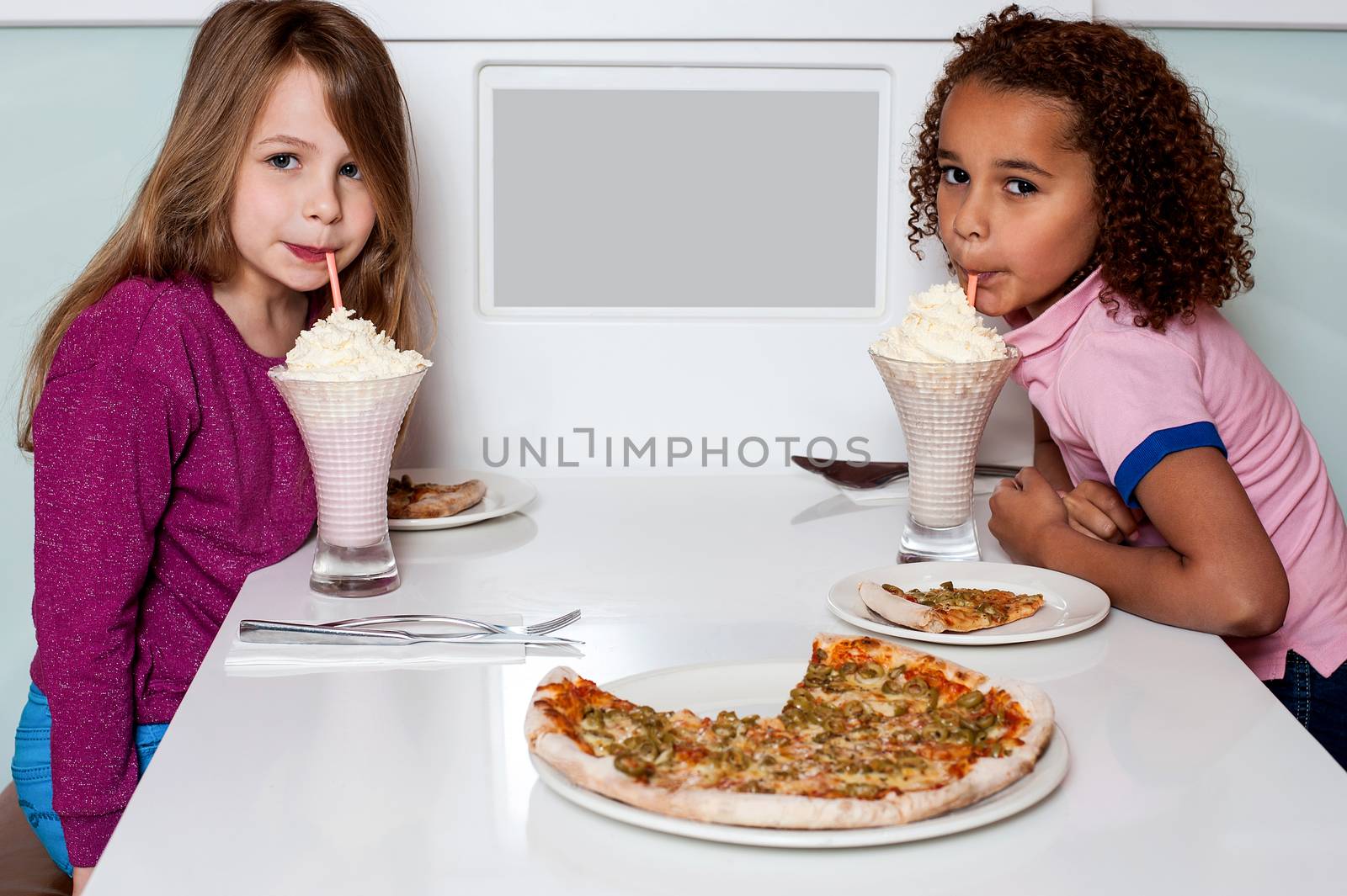 Little girls having a nice time in restaurant