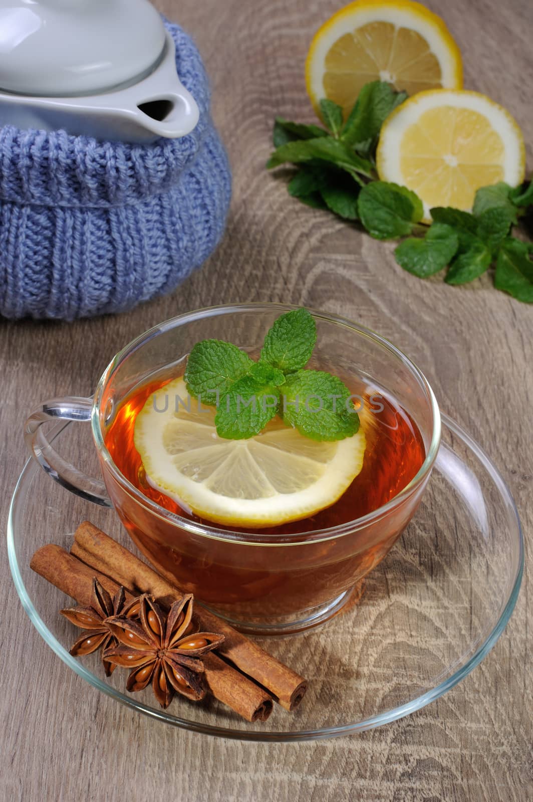 Cup of tea with a slice of lemon, mint and cinnamon