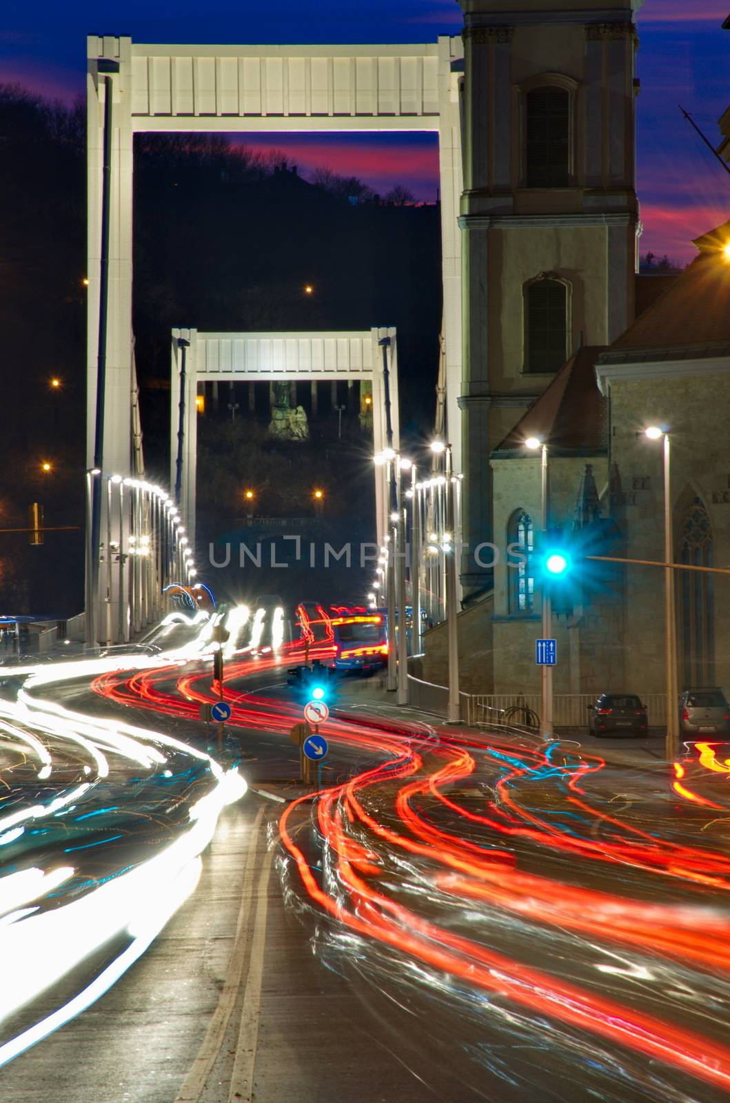 Traffic on the bridge at night in Budapest, Hungary by anderm