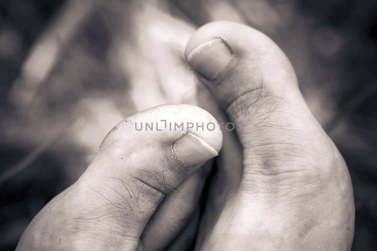 Big man barefoot close-up thumbs