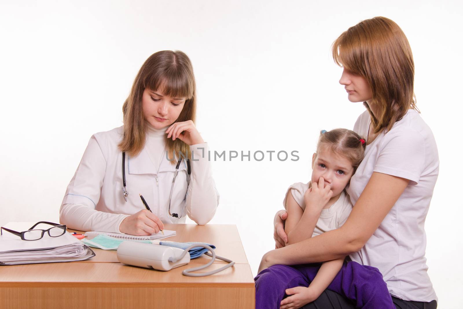 Woman with a small child on reception at the pediatrician
