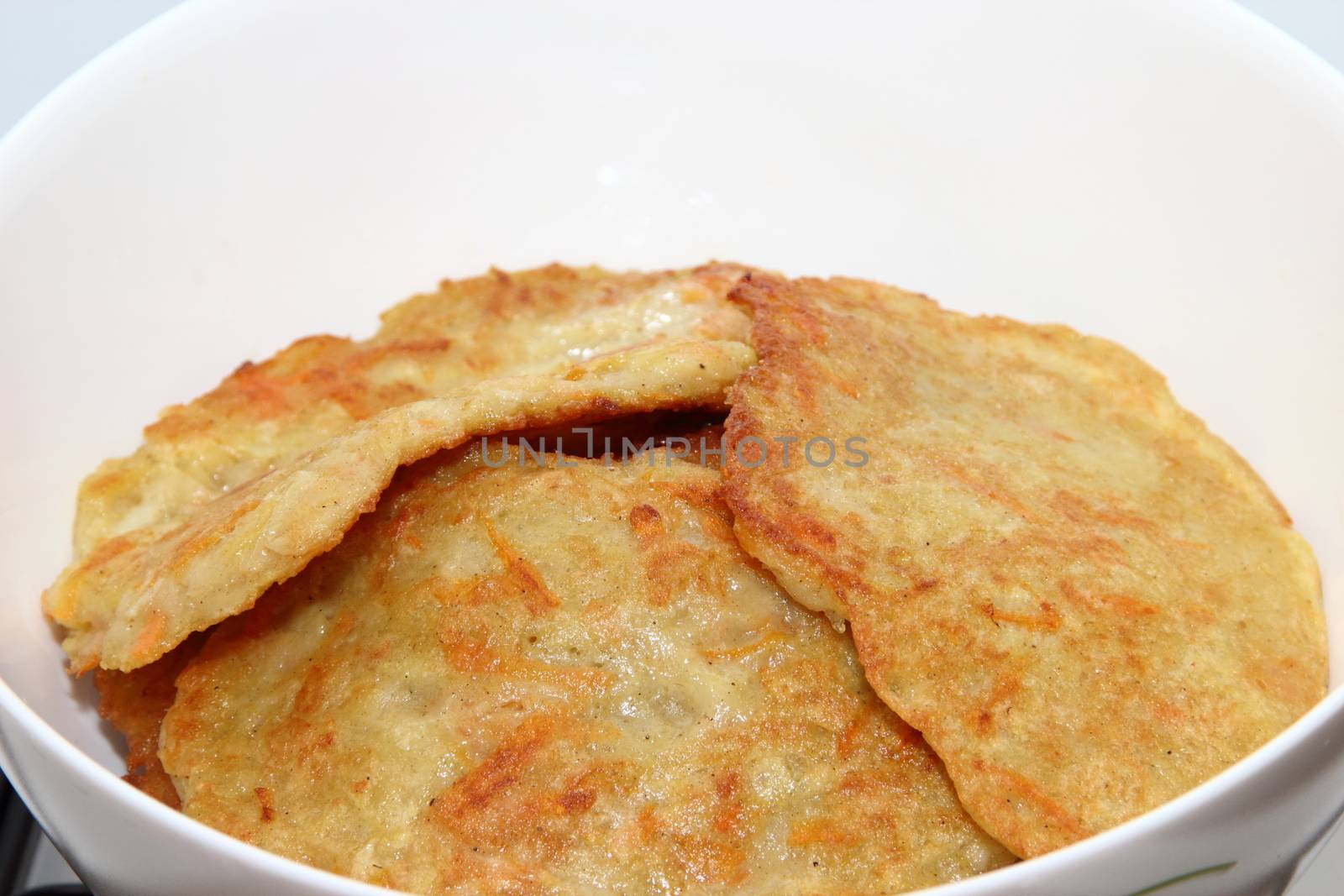 Potato pancakes with sour cream with carrot. Preparation of meals