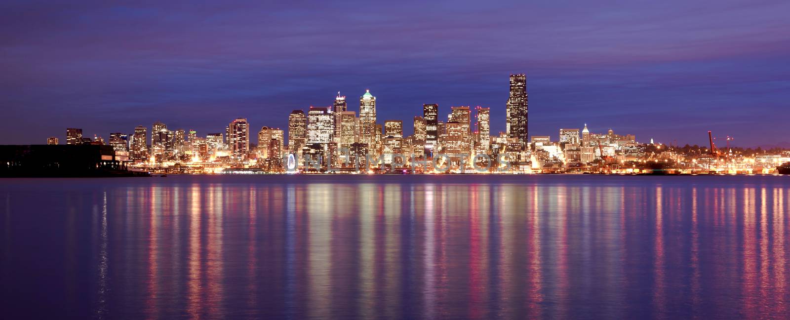 Night falls showing reflections in the smooth water of Elliott Bay