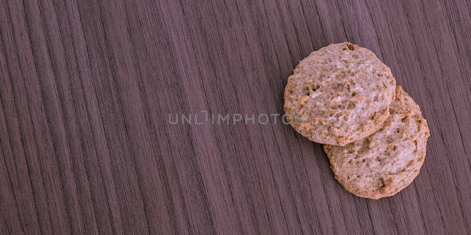 Two fresh integral cookies over wood background 