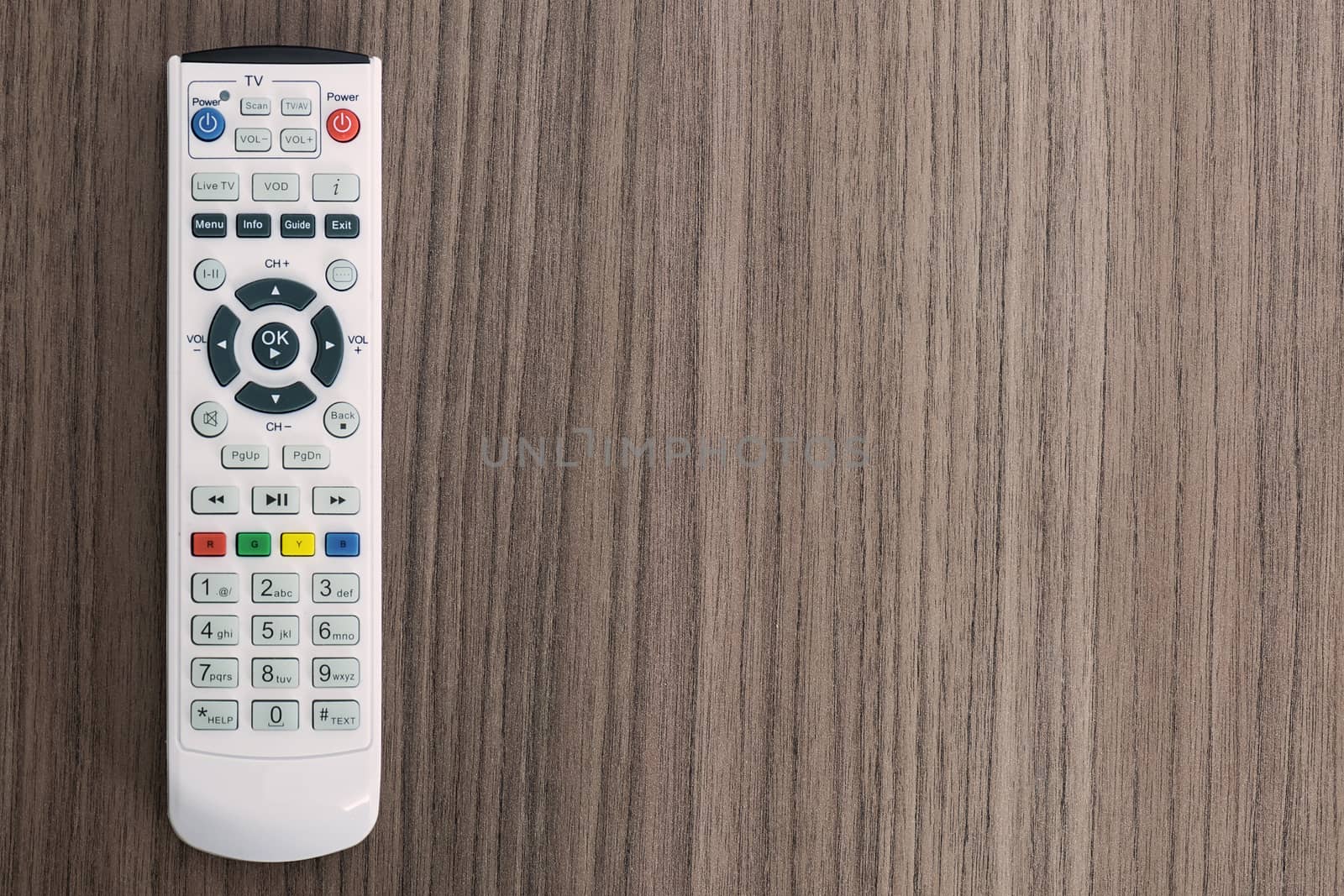 A remote control over a wood background 