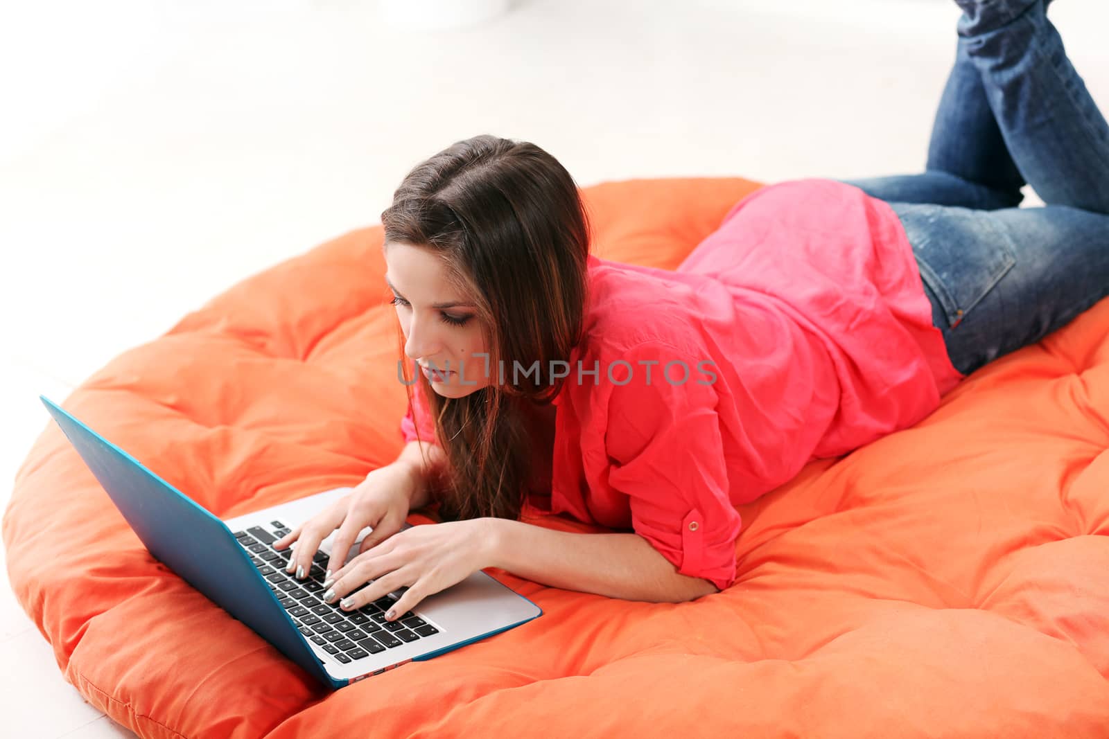 Young woman lying on a blanket with PC by rufatjumali