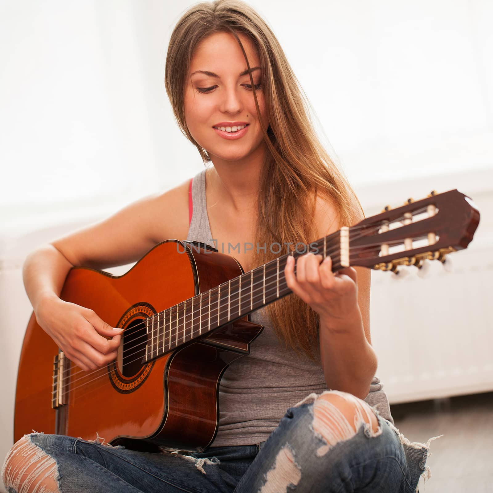 Young beautiful caucasian woman in casual playing guitar