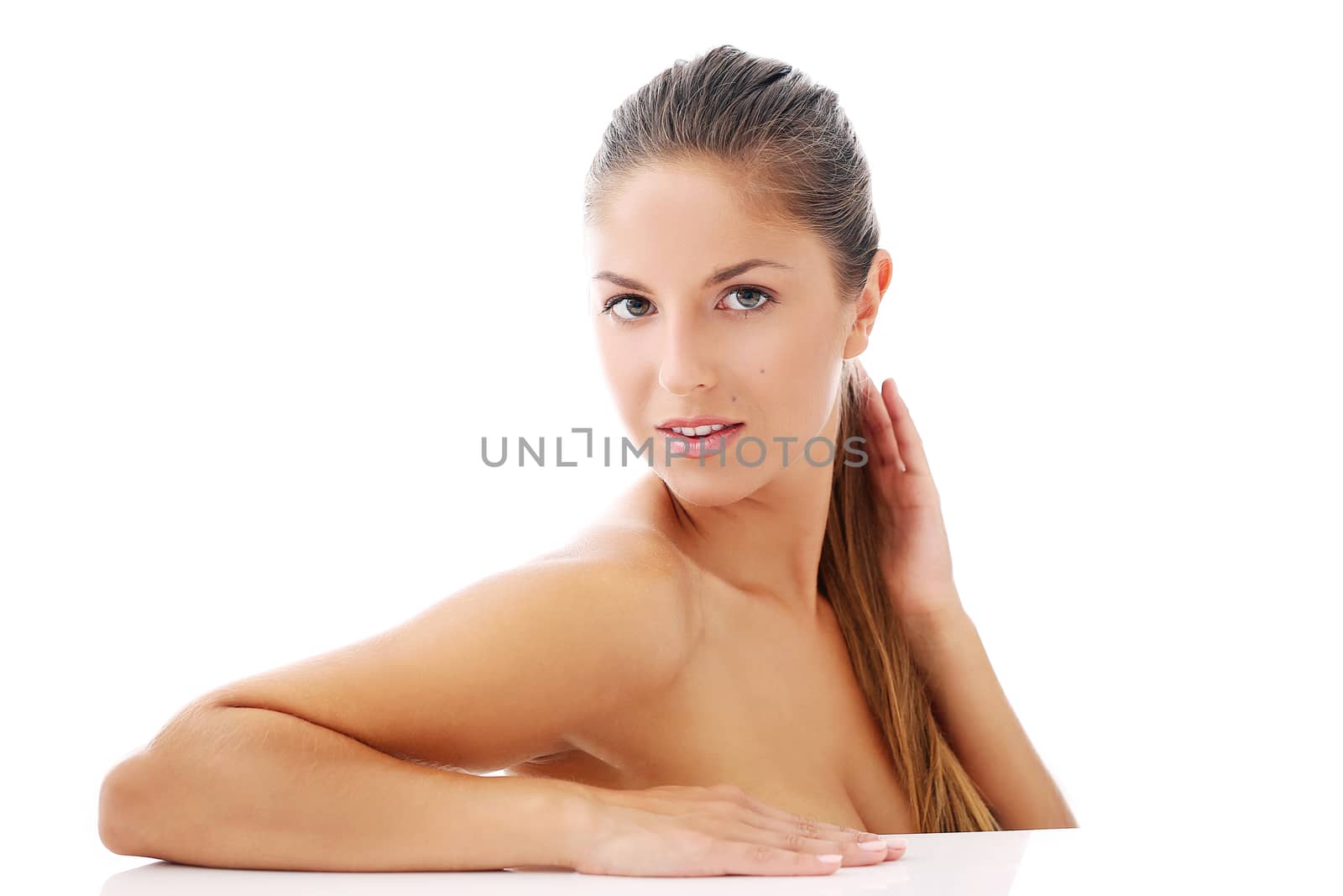 Portrait of a beautiful woman who is posing happily and tenderly over a white background