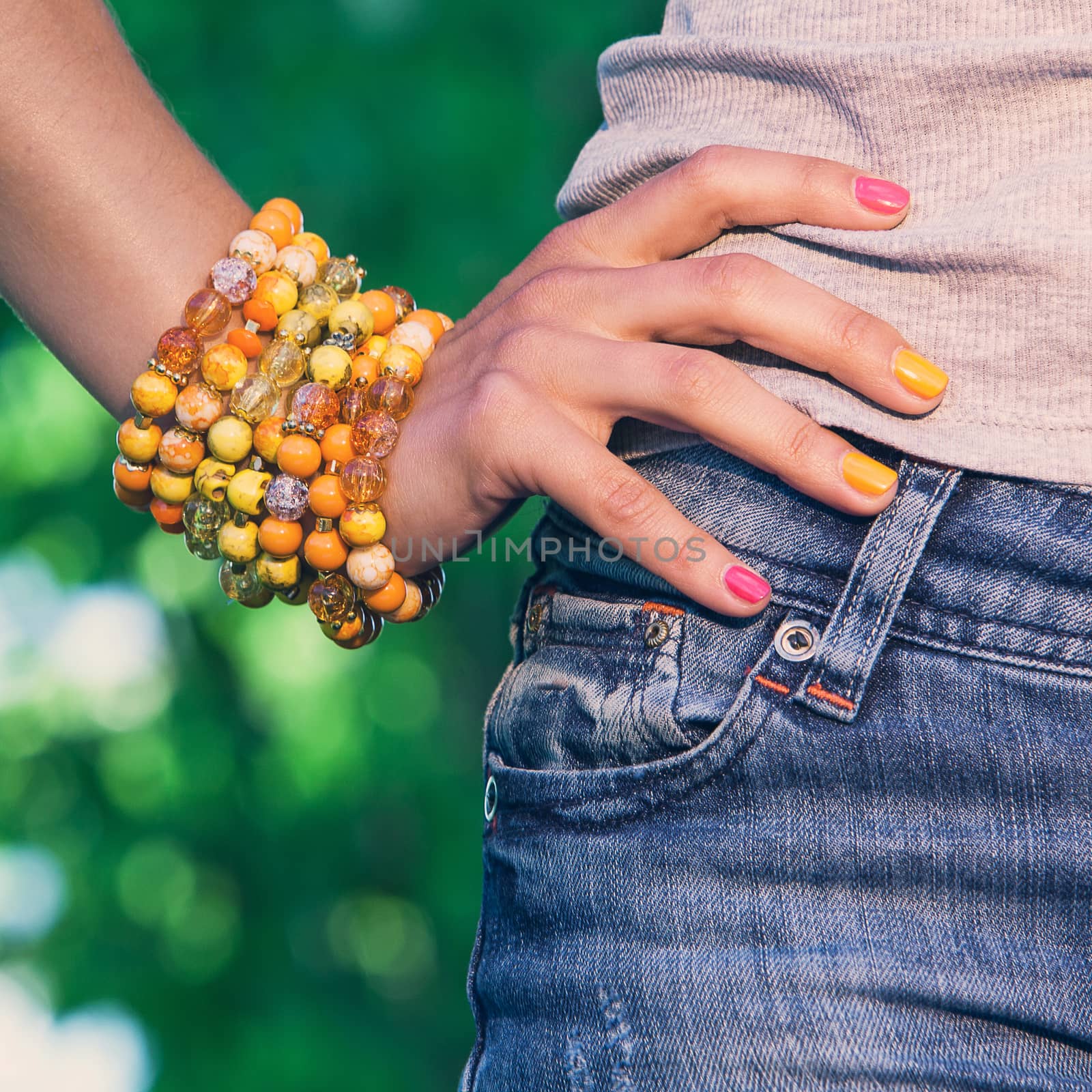 Woman wearing a colorful bracelet while hanging outside