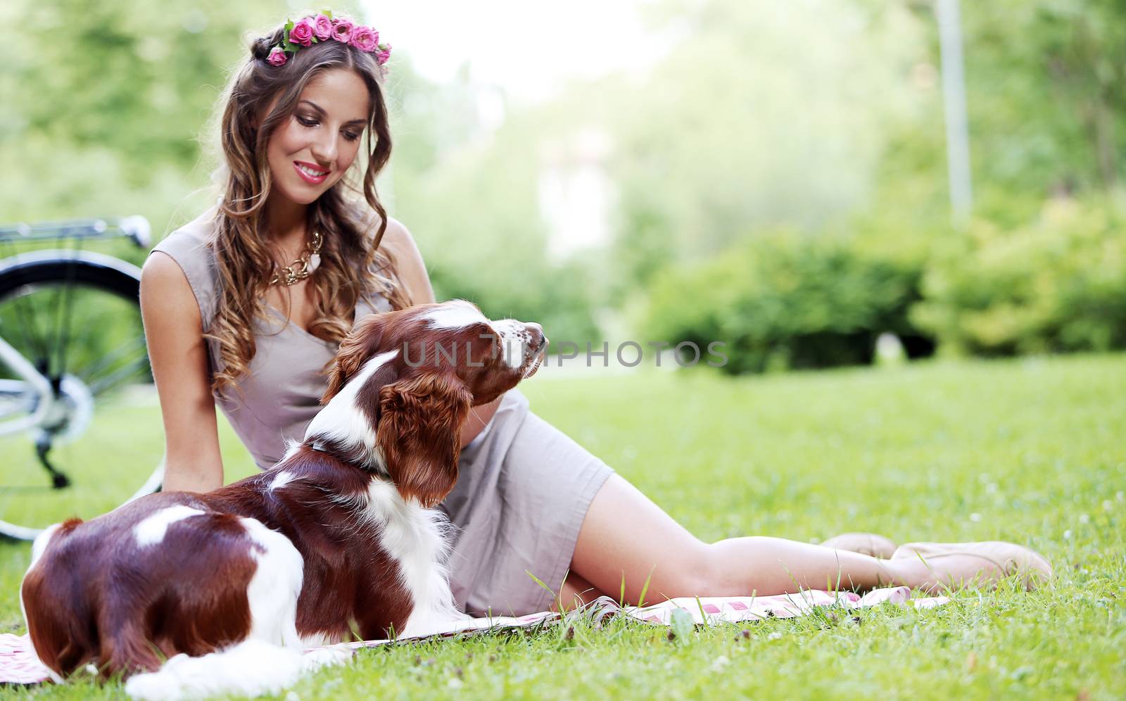 Portrait of a beautiful girl hanging out with a dog in a park
