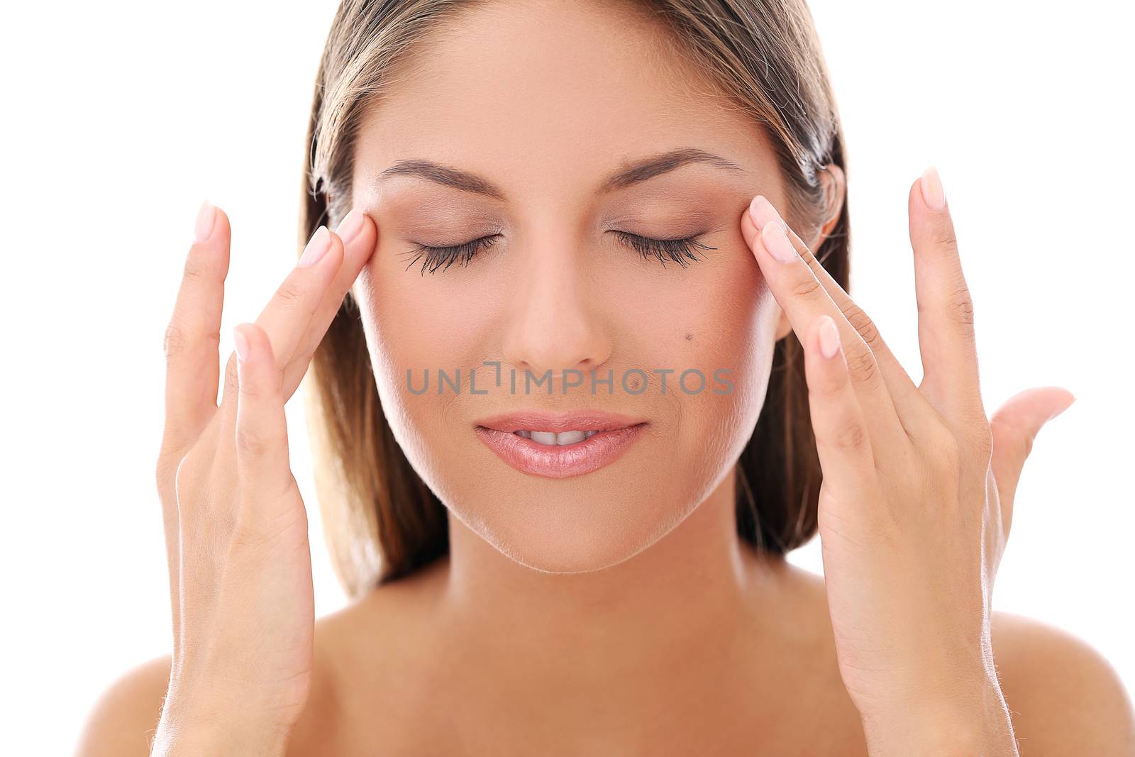 Portrait of a beautiful woman touching her face with her eyes closed