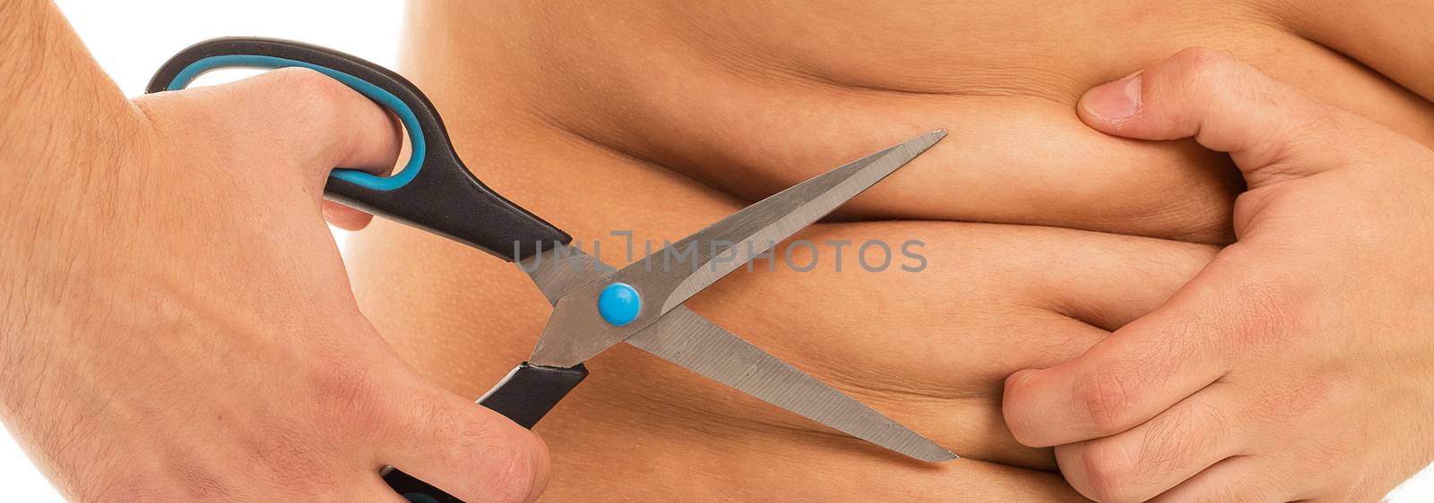 Man with scissors is trying to cut off his extra fat