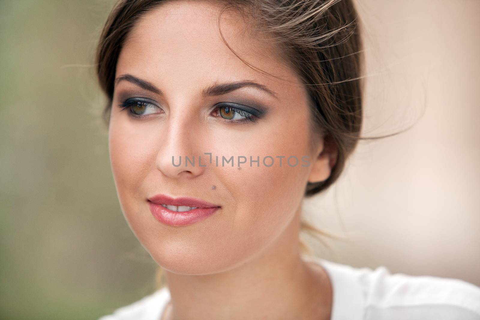 Portrait of beautiful young caucasian woman with makeup outdoors