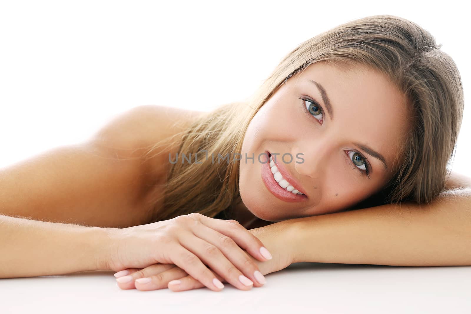 Portrait of a beautiful girl who is lying on her arms
